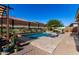 Outdoor pool area with stone accents, desert mural wall, and shaded lounge area at 3202 N 197Th Ave, Buckeye, AZ 85396