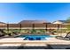 Scenic backyard pool with desert mural, lounge chairs, and covered seating area at 3202 N 197Th Ave, Buckeye, AZ 85396