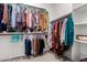 Walk-in closet with ample storage space for hanging clothes, shelving, and carpeted floor at 3202 N 197Th Ave, Buckeye, AZ 85396