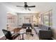 Bright living room featuring hardwood floors, a geometric rug, and a modern ceiling fan at 322 E Mitchell Dr, Phoenix, AZ 85012