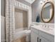 Cozy bathroom features a shower-tub combination and classic vanity with charming oval mirror at 3619 W Angela Dr, Glendale, AZ 85308