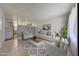 Bright living room with stylish decor, neutral furniture, and an open floor plan into kitchen at 3619 W Angela Dr, Glendale, AZ 85308