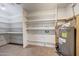 Organized storage area with shelves and water heater, maximizing space efficiently at 3619 W Angela Dr, Glendale, AZ 85308