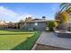 Relaxing backyard featuring artificial grass, a built-in fire pit, patio furniture, and a covered seating area at 3834 E Shaw Butte Dr, Phoenix, AZ 85028