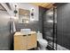 Modern bathroom featuring dark tile, a black framed shower, and a floating vanity at 3834 E Shaw Butte Dr, Phoenix, AZ 85028