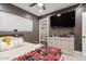 Cozy bedroom with ceiling fan, window and sports memorabilia displayed on shelves at 3834 E Shaw Butte Dr, Phoenix, AZ 85028