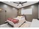 Comfortable bedroom featuring a ceiling fan, a decorative blanket and gray walls at 3834 E Shaw Butte Dr, Phoenix, AZ 85028