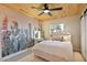 Comfortable bedroom with a bed, window, and a vanity with decorative floral accents at 3834 E Shaw Butte Dr, Phoenix, AZ 85028