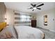 Bright bedroom featuring a ceiling fan, neutral walls, and sliding mirrored closet doors at 3834 E Shaw Butte Dr, Phoenix, AZ 85028