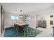 Dining area with a wooden table, modern chairs, and graphic rug at 3834 E Shaw Butte Dr, Phoenix, AZ 85028