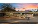 Charming single-story home with a well-maintained landscape, desert-style front yard, and a spacious two-car garage at 3834 E Shaw Butte Dr, Phoenix, AZ 85028