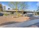 Inviting single-story home with desert-style landscape, with a xeriscaped front yard, and a convenient two-car garage at 3834 E Shaw Butte Dr, Phoenix, AZ 85028