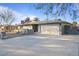 Well-kept single-story home featuring a spacious driveway leading to an attached two-car garage with desert-style landscaping at 3834 E Shaw Butte Dr, Phoenix, AZ 85028