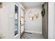 Modern foyer with a stylish mirror, unique door design, and a glimpse into the home's contemporary interior at 3834 E Shaw Butte Dr, Phoenix, AZ 85028