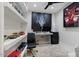 Home office featuring a desk with monitors, a black accent wall and sports memorabilia at 3834 E Shaw Butte Dr, Phoenix, AZ 85028