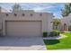 Well-maintained garage with a neat driveway and lush landscaping enhance curb appeal at 4091 E Round Hill Dr, Phoenix, AZ 85028