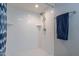 Modern shower with white herringbone tile, white mosaic floor, and a chrome shower head at 4091 E Round Hill Dr, Phoenix, AZ 85028