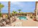 Serene pool area with palm trees, lounge chairs, and lush landscaping at 41573 W Anne Ln, Maricopa, AZ 85138