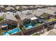 Aerial view of home showcasing backyard oasis with pool, hot tub, and easy-care synthetic grass at 42660 W Oakland Dr, Maricopa, AZ 85138