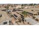 This aerial view highlights the solar panels, desert landscaping, and tile roof of the property in a suburban neighborhood at 42660 W Oakland Dr, Maricopa, AZ 85138