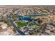 Panoramic aerial view showcases a community with a golf course, lake, park, and residential area at 42660 W Oakland Dr, Maricopa, AZ 85138