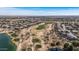 Aerial view of a desert community with a golf course, winding paths, mature trees, and residential homes at 42660 W Oakland Dr, Maricopa, AZ 85138