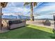 This backyard features a hot tub, and outdoor fireplace and a painted block wall creating a private oasis at 42660 W Oakland Dr, Maricopa, AZ 85138