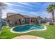 Beautiful backyard featuring a private pool, turf lawn, and covered patio at 42660 W Oakland Dr, Maricopa, AZ 85138
