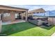 This backyard offers an inviting hot tub, complemented by a covered patio area, perfect for relaxation and entertainment at 42660 W Oakland Dr, Maricopa, AZ 85138