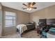 Bedroom featuring carpet, ceiling fan, desk, and a window with blinds at 42660 W Oakland Dr, Maricopa, AZ 85138