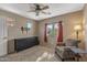 Relaxing bedroom featuring a ceiling fan, neutral walls, and natural light through the window at 42660 W Oakland Dr, Maricopa, AZ 85138