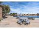 Inviting community space with picnic tables and views of the lake with fountains at 42660 W Oakland Dr, Maricopa, AZ 85138