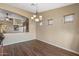 Formal dining room with natural light, modern chandelier, and lovely wood flooring at 42660 W Oakland Dr, Maricopa, AZ 85138