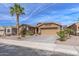 Charming single-story home features a neutral exterior, desert landscaping, and a two-car garage at 42660 W Oakland Dr, Maricopa, AZ 85138