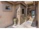 Inviting front entry with decorative art, potted plants, and a wrought iron security door at 42660 W Oakland Dr, Maricopa, AZ 85138