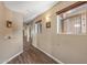 Hallway with wood floors and windows looking onto a courtyard with decorative wrought iron at 42660 W Oakland Dr, Maricopa, AZ 85138