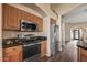 The stainless steel refrigerator and microwave complement the wood cabinetry in the spacious kitchen at 42660 W Oakland Dr, Maricopa, AZ 85138