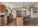 Beautiful kitchen with stainless steel appliances, oak cabinets, a center island, and pendant lighting at 42660 W Oakland Dr, Maricopa, AZ 85138