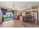 An open kitchen featuring wooden cabinets, stainless steel appliances, and island with bar seating at 42660 W Oakland Dr, Maricopa, AZ 85138