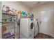 Laundry room with washer, dryer, wire shelving, and convenient storage space at 42660 W Oakland Dr, Maricopa, AZ 85138