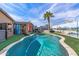 Backyard with a sparkling private pool, green turf, and custom desert landscape mural on the wall at 42660 W Oakland Dr, Maricopa, AZ 85138