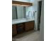 Bathroom featuring a large mirror, sink, and vanity with white towels and modern fixtures at 459 S Boojum Way, Mesa, AZ 85208