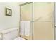 Bathroom with a walk-in shower featuring a frosted sliding glass door and towel rack at 459 S Boojum Way, Mesa, AZ 85208