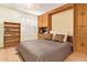 Bedroom area with hardwood floors, custom wood shelving and cabinets, and an open Murphy bed at 459 S Boojum Way, Mesa, AZ 85208