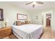 Well-lit bedroom featuring a double bed, wooden furniture, neutral walls, and a doorway to the walk-in closet at 459 S Boojum Way, Mesa, AZ 85208