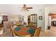 Open-concept dining room with wooden chairs, a ceiling fan, and view to the living room at 459 S Boojum Way, Mesa, AZ 85208