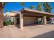 Single-story tan house with a covered carport, desert landscaping and blue golf cart at 459 S Boojum Way, Mesa, AZ 85208