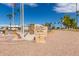 Community landmark with fountain of the Sun, featuring a stone monument and flags at 459 S Boojum Way, Mesa, AZ 85208