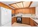 Spacious eat-in kitchen features wood cabinets, tile countertops, and an electric range at 459 S Boojum Way, Mesa, AZ 85208