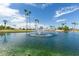 Scenic view of the lake with a fountain surrounded by lush greenery and palm trees at 459 S Boojum Way, Mesa, AZ 85208